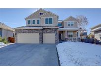 Two-story house with stone accents and a three-car garage at 11575 Terrawood Ln, Parker, CO 80134