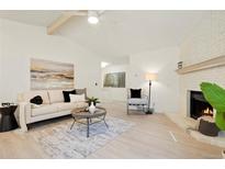 Bright living room features a fireplace, hardwood floors, and comfy seating at 2735 Denver Ave, Longmont, CO 80503