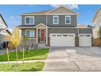 Attractive two-story home with a front porch, three-car garage, and landscaped yard at 4205 Sandstone Dr, Mead, CO 80504