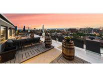 Private rooftop deck with city views and comfortable seating at 669 N Washington St # 901, Denver, CO 80203