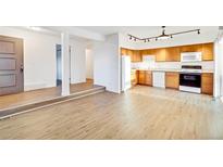 Bright kitchen with light wood cabinets and modern appliances at 13651 E Yale Ave # C, Aurora, CO 80014