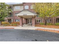 Brick building exterior with covered entryway and landscaping at 2894 W Riverwalk Cir # B219, Littleton, CO 80123