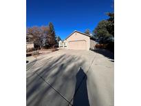 Ranch-style house with attached garage and landscaping at 18269 E Hampden Pl, Aurora, CO 80013