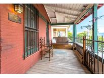 Charming front porch with wooden floors and seating at 1520 S Acoma St, Denver, CO 80223