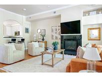 Bright living room featuring a fireplace and comfortable seating at 1489 Steele St # 118, Denver, CO 80206