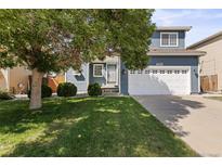 Two-story house with attached garage and landscaped lawn at 19895 E 40Th Pl, Denver, CO 80249