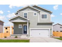 Two-story home with grey siding and a two-car garage at 7238 Arkansas St, Frederick, CO 80530