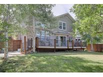 Spacious backyard with a large deck and mature trees at 2599 S Jebel Way, Aurora, CO 80013