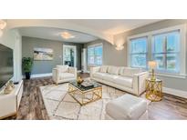 Bright living room with hardwood floors and white furniture at 101 S 11Th Ave, Brighton, CO 80601