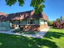 Exterior view of a ranch home with a well-manicured lawn at 8870 W Jewell Ave # 14, Lakewood, CO 80232
