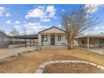 Ranch style home with carport and landscaped yard at 7511 Leyden St, Commerce City, CO 80022