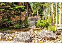 Attractive exterior of mountain condo building with stone accents and landscaping at 465 Four Oclock Rd # 323, Breckenridge, CO 80424