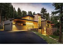Stunning contemporary home with mountain views, expansive windows, and a spacious driveway at 32651 Buffalo Creek Rd, Evergreen, CO 80439