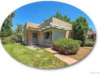 Charming ranch home with a manicured lawn and walkway at 200 Colorado Blvd, Denver, CO 80206