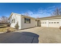 Ranch style home with attached two-car garage and landscaped yard at 217 S 25Th Ave, Brighton, CO 80601