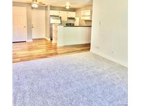 Open living room with kitchen and wood flooring at 747 W 96Th Ave # 10, Thornton, CO 80260