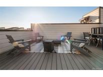 Modern rooftop deck with fire pit and seating at 13808 Via Varra, Broomfield, CO 80020