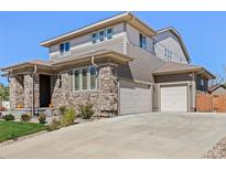 Two-story house with stone and siding exterior at 15004 W 63Rd Ave, Arvada, CO 80403