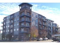 Modern multi-story condo building with blue accents and balconies at 1488 Madison St # 211, Denver, CO 80206