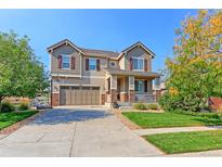 Two-story house with large windows, attached garage, and landscaped yard at 16021 Williams Pl, Broomfield, CO 80023