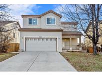 Two-story house with attached garage and landscaped yard at 5241 S Shawnee St, Aurora, CO 80015