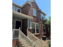 Brick townhouse exterior with a front porch and stairs at 22975 E Ontario Dr # 106, Aurora, CO 80016