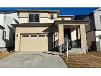 Two story home with neutral exterior and two car garage at 9238 Truckee Ct, Commerce City, CO 80022