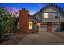 Two-story townhome with brick facade and attached garage at 1605 Geneva Cir, Longmont, CO 80503