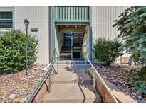 Exterior view of building entrance with stairs and landscaping at 2160 S Vaughn Way # 304C, Aurora, CO 80014