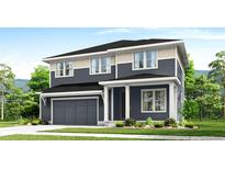 Two-story home with gray siding, white trim, and a two-car garage at 1826 Hickory Ave, Erie, CO 80516