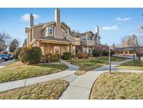 Inviting exterior of a two-story condo with a welcoming walkway and landscaping at 4760 S Wadsworth Blvd # 108, Littleton, CO 80123