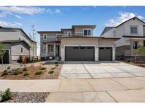 Two-story house with two-car garage and landscaped front yard at 3442 N Gold Bug Ct, Aurora, CO 80019