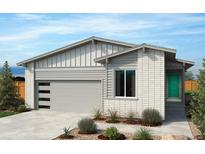 Modern two-story home with gray siding and green door at 9274 Biscay St, Commerce City, CO 80022