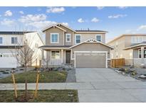 Two-story house with gray siding, attached garage, and landscaped front yard at 1120 Joseph Pl, Erie, CO 80026