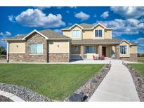 Two-story house exterior with stone and siding at 41860 Muirfield Loop, Elizabeth, CO 80107
