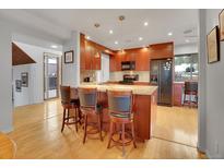 Open concept kitchen with island and breakfast bar at 23485 Bluestem Dr, Golden, CO 80401