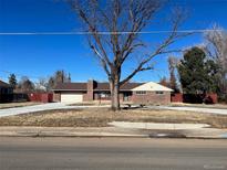 Ranch style home with large yard and circular driveway at 6601 E Exposition Ave, Denver, CO 80224
