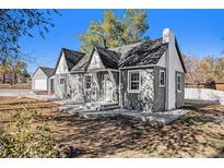Charming bungalow with gray siding, a new roof, and a spacious yard at 2801 W Dartmouth Ave, Denver, CO 80236