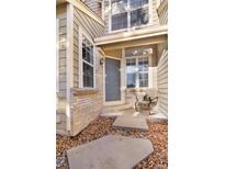 Inviting front entrance with gray door and small patio at 7373 E Iowa Ave # 1101, Denver, CO 80231