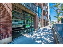 Commercial storefront with large windows and brick facade at 1401 Wewatta St # 102, Denver, CO 80202