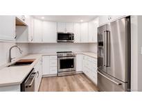 Modern kitchen with stainless steel appliances and white cabinets at 3144 S Wheeling Way # 107, Aurora, CO 80014