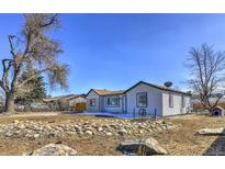Ranch style home with landscaped yard, rock garden, and fenced yard at 15360 W 44Th Ave, Golden, CO 80403