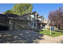 Two-story home with attached garage and landscaping at 21064 E Crestline Cir, Centennial, CO 80015