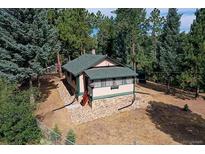 Secluded mountain cabin nestled in a wooded lot with a spacious yard at 5673 Santa Clara Rd, Indian Hills, CO 80454