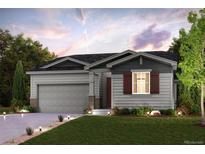 Two-story house with gray siding, brown accents, and a two-car garage at 9994 Racine St, Commerce City, CO 80022