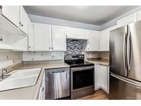 Galley kitchen with stainless steel appliances at 745 S Alton Way # 9A, Denver, CO 80247