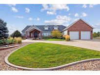 Brick and shingle house with a two car garage at 29850 E 167Th Pl, Brighton, CO 80603
