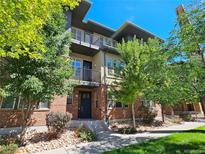 Modern brick townhome with landscaping and balcony at 6435 E Cedar Ave, Denver, CO 80224