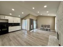 Open concept kitchen and living room with modern appliances and fireplace at 3414 S Locust St # D, Denver, CO 80222