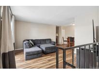 Spacious living room with L-shaped sofa and access to a deck at 9901 E Evans Ave # 7D, Aurora, CO 80247